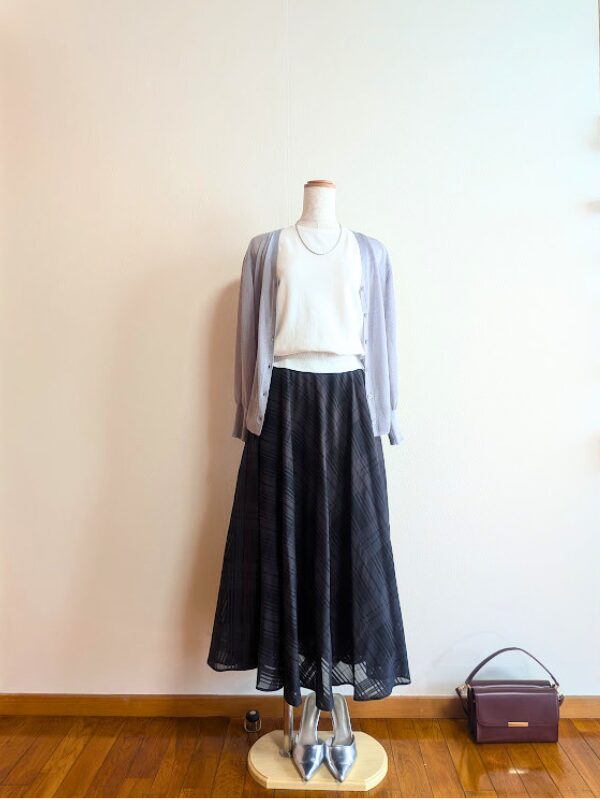 40代・50代コーデ ①ホワイトノースリーブニットにブラックシアースカートを合わせ、ライトグレーシアーカーディガンを掛けたトルソーコーデ